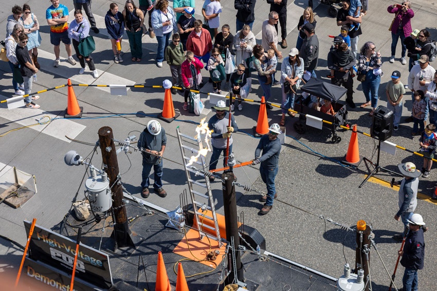 PUD lineworkers create an arc of electrical energy during a safety demonstration