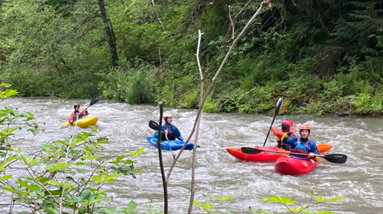 Brightly colored kayaks flow down the Sultan